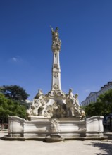 Rococo fountain with depictions of the four seasons and St George as dragon slayer on obelisk,