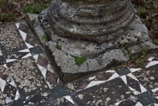 Column base on mosaic floor