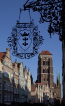 West view through Jopengasse with town houses, wrought-iron hanger with Gdansk coat of arms at the