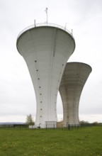 Bresse, 2 identical water towers in a row on a meadow