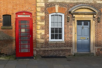 Traditional K6 red phone box and historic Houston Castle Hill, city of Lincoln, Lincolnshire,