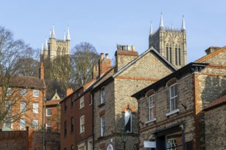 Cathedral towers rising above historic buildings, Steep Hill, Lincoln, Lincolnshire, England, UK