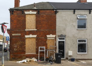 Derelict empty boarded-up house next to renovated house, Willingham Terrace, Grimsby, north east