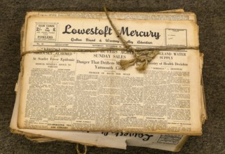 String tied bundle of 1930s copies Lowestoft Mercury local newspaper, Suffolk, England, UK