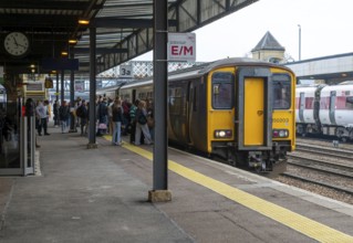 People boarding British Rail Class 150 Sprinter passenger train, Lincoln railway station, city of