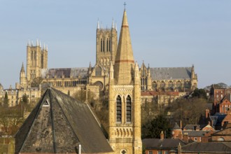 Church of Saint Hugh in foreground with towers of cathedral behind, Lincoln, Lincolnshire, England,