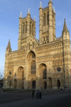 West frontage of cathedral church in evening light, Lincoln, Lincolnshire, England, UK