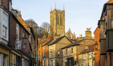 Cathedral tower rising above buildings, Steep Hill in evening light, Lincoln, Lincolnshire,