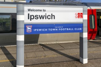 Welcome to Ipswich sign, home of Ipswich Town Football Club, platform of railway station, Ipswich,