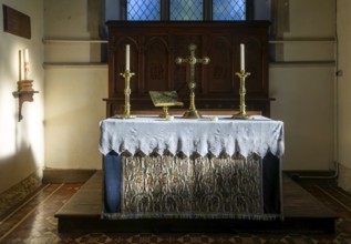 Altar with candles and cross inside parish church of Saint Mary, Walpole, Suffolk, England, UK