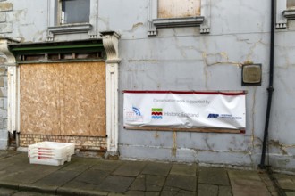 Conservation work sign banner, derelict empty disused property in Grimsby docks, north east