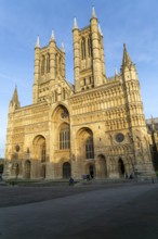 West frontage of cathedral church in evening light, Lincoln, Lincolnshire, England, UK