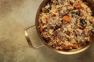 Rice dish with meat and dried fruits, in a large pot, pilaf, homemade, no people