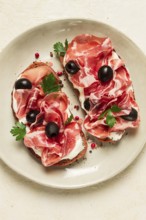 Sandwich with cream cheese, prosciutto with olives, breakfast