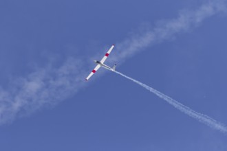 Airshow, glider with contrails against blue sky, Montreal, Province of Quebec, Canada, North