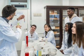 Multi ethnic group of university students attending a chemistry lesson in a laboratory, teacher