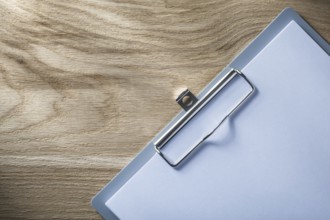 Clipboard blank paper on wooden board