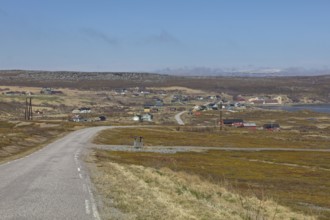 View form Stuorraavuonna road looking at town of Karlebotn in summer with clouds in the sky,