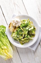 Baked Romaine lettuce with garlic and pine cores