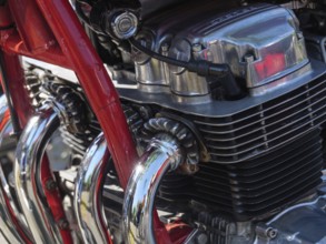 Close-up of a motorbike with red painted frame and chromed cylinder heads, Appelhülsen,