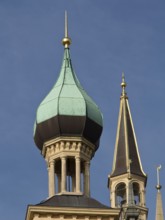 Two architecturally decorated towers with green copper roofs against a blue sky, Schwerin, Germany,