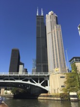 Skyscraper next to a bridge over a river in a modern urban environment, chicago, illinois, usa