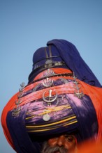 Nihang or Sikh warrior in pagdi or headgear with sword during Hola Mohalla festival at Anandpur