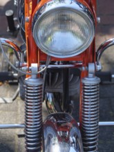 Frontal view of an orange motorbike with shiny chrome headlight, Appelhülsen, münsterland, germany