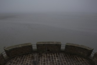 Mont-Saint-Michel, monastery mountain, view from the Tour Cholet into the mudflats in foggy weather