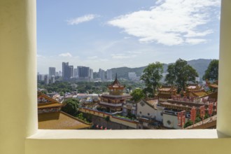 View from a window of a temple, mountains and the city skyline below, penang, malaysia