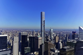 Rockefeller Center observation deck, Modern skyscrapers towering under a bright blue sky above the