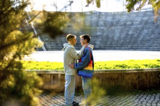 Two young men embracing in a sunlit park, celebrating love, acceptance, and the vibrant spirit of