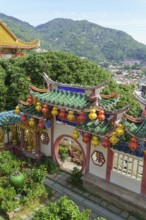 Colourful entrance gate with decorative lanterns and green surroundings, penang, malaysia