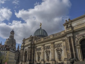 Monumental building with dome and angel on roof under blue sky, dresden, saxony, germany