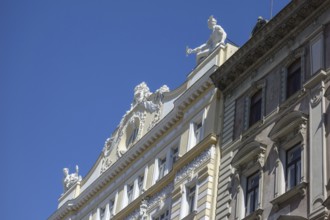 Decoratively designed building façade with statues on the roof, vienna, austria