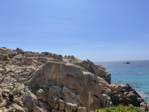 Rocky coast with a view of the blue sea as far as the horizon under a clear sky, cagliari,