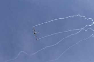 Airshow, glider with contrails against blue sky, Montreal, Province of Quebec, Canada, North