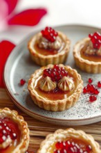 A culinary shot of miniature fruit tarts on a speckled plate. The tarts boast a flaky crust, filled