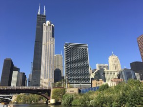 Various skyscrapers and modern architecture along a river under a clear sky, chicago, illinois, usa