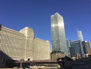 Skyline of a city with modern and historic buildings under a blue sky, chicago, usa