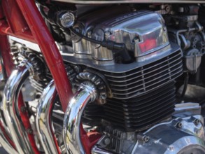 Detailed view of a chromed motorbike engine with red frame and cylinders in focus, Appelhülsen,