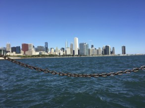 View across the sea to the coastline with a chain in the foreground, chicago, illinois, usa