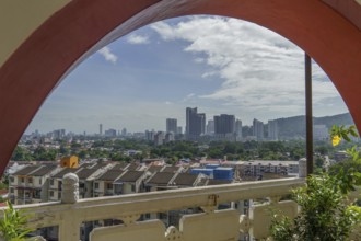 View through an arch onto a modern cityscape, penang, malaysia