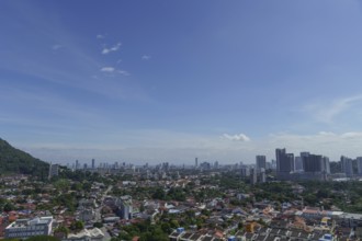 Big city under a clear blue sky with scattered clouds, penang, malaysia