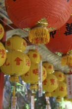 Close-up of red and yellow lanterns with Asian characters creating a festive atmosphere, penang,