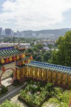 Overview of a colourful temple garden with city in the background, penang, malaysia