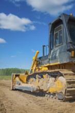 Bulldozer on sand view from back