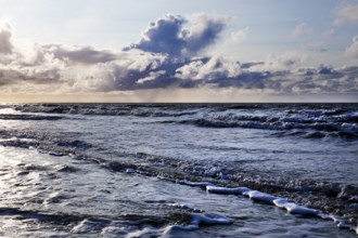 Outgoing tidal fringe in the mudflat landscape with dramatic clouds, North Sea, Norderney Island,