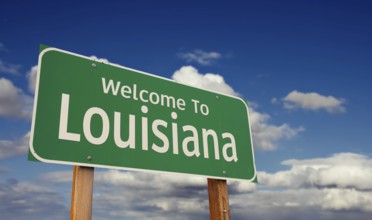 Welcome to louisiana green road sign over blue sky with some clouds