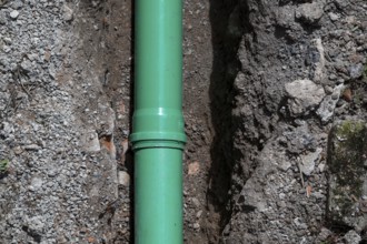 Newly laid green sewage pipe in a trench, Stuttgart, Baden-Württemberg